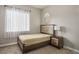 Inviting bedroom with light-toned walls, and dark-stained furniture at 2785 Rosenhearty Dr, Henderson, NV 89044
