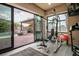 Bright exercise room with fitness equipment, large windows, and views of the backyard pool and patio at 2785 Rosenhearty Dr, Henderson, NV 89044