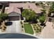 Lovely home featuring a manicured lawn, mature trees, and a welcoming facade, creating a warm and inviting curb appeal at 2785 Rosenhearty Dr, Henderson, NV 89044
