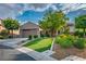 Well-maintained single-story home with a vibrant lawn, desert landscape, and convenient two-car garage at 2785 Rosenhearty Dr, Henderson, NV 89044