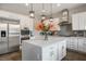 Modern kitchen with stainless steel appliances, white cabinets, a tile backsplash, and a center island at 2785 Rosenhearty Dr, Henderson, NV 89044
