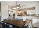 Modern kitchen features white cabinets, stainless steel appliances, and an island with marble countertops at 2785 Rosenhearty Dr, Henderson, NV 89044