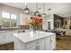 Bright kitchen featuring white cabinets, stainless steel appliances, island with quartz countertops, and stylish pendant lighting at 2785 Rosenhearty Dr, Henderson, NV 89044