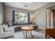 Inviting living room features a comfortable gray sectional sofa and stylish area rug at 2785 Rosenhearty Dr, Henderson, NV 89044