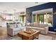 Open-concept living room connected to kitchen, with sectional sofa and backyard views at 2785 Rosenhearty Dr, Henderson, NV 89044