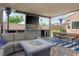 Spacious covered patio features comfortable seating, a dining table, and a built-in entertainment center at 2785 Rosenhearty Dr, Henderson, NV 89044
