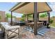 Charming covered patio area with comfortable seating, a dining table, and built-in entertainment features at 2785 Rosenhearty Dr, Henderson, NV 89044