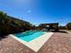 Inviting backyard pool with a view of an outdoor kitchen under a pergola, surrounded by palm trees at 2785 Rosenhearty Dr, Henderson, NV 89044