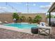 Backyard pool with stylish patio furniture, lush palm trees, and string lights creating a relaxing ambiance at 2785 Rosenhearty Dr, Henderson, NV 89044