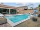 Sparkling backyard pool with surrounding patio, lounge chairs, and well-maintained landscaping at 2785 Rosenhearty Dr, Henderson, NV 89044