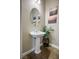 Charming half-bath with vessel sink, artistic wall decor and custom tile floor at 2785 Rosenhearty Dr, Henderson, NV 89044