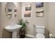 Elegant powder room with pedestal sink and coastal-themed decor at 2785 Rosenhearty Dr, Henderson, NV 89044