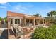 A cozy backyard with a fire pit, seating, a pergola and an outdoor kitchen perfect for entertaining guests at 2917 Golf Links Dr, Las Vegas, NV 89134