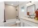 Updated bathroom featuring a tiled shower-tub, modern fixtures, and a neutral color palette at 2917 Golf Links Dr, Las Vegas, NV 89134