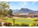 Exterior view of the home with landscaped yard and beautiful mountain views beyond the golf course at 2917 Golf Links Dr, Las Vegas, NV 89134