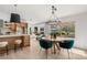 Bright open kitchen and dining area with bar seating, round table, and exterior view at 2917 Golf Links Dr, Las Vegas, NV 89134