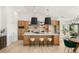 Modern kitchen featuring an island with seating, custom cabinetry, and stainless steel appliances at 2917 Golf Links Dr, Las Vegas, NV 89134