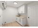 Clean laundry room with white cabinets, modern sink, and neutral countertop at 2917 Golf Links Dr, Las Vegas, NV 89134