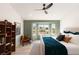 Comfortable bedroom with view of outdoor fireplace, accent chair, and custom shelving at 2917 Golf Links Dr, Las Vegas, NV 89134