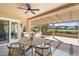 Covered patio with ceiling fan, built-in grill, outdoor seating and views of the golf course and mountains at 2917 Golf Links Dr, Las Vegas, NV 89134