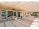 Covered patio with an outdoor kitchen, ceiling fan, outdoor seating and access to the home's interior at 2917 Golf Links Dr, Las Vegas, NV 89134