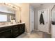 Bathroom features dual sinks, dark wood cabinetry, and updated lighting at 3045 Camino Rico Ave, Henderson, NV 89044
