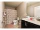 Well-lit bathroom showcasing a decorative shower curtain, sink, and modern fixtures at 3045 Camino Rico Ave, Henderson, NV 89044