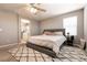 Cozy bedroom is complete with soft carpet, overhead ceiling fan, and ensuite bathroom at 3045 Camino Rico Ave, Henderson, NV 89044