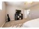 Bedroom featuring carpeted floors, a dark storage unit, and a view into ensuite bathroom at 3045 Camino Rico Ave, Henderson, NV 89044