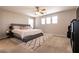 This bedroom features neutral walls, plush carpet, and a ceiling fan for comfort at 3045 Camino Rico Ave, Henderson, NV 89044