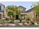 Two-story home featuring attractive landscaping and an inviting, covered front porch at 3045 Camino Rico Ave, Henderson, NV 89044