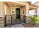 Close-up of a covered porch with stone pillars and an ornamental iron fence at 3045 Camino Rico Ave, Henderson, NV 89044