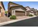 Attached two-car garage with a paved driveway and well-maintained landscaping at 3045 Camino Rico Ave, Henderson, NV 89044