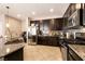 Contemporary kitchen featuring stainless steel appliances, granite counters, and dark wood cabinets at 3045 Camino Rico Ave, Henderson, NV 89044