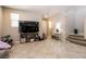 Spacious living room with tile flooring, natural light, and stairs leading up to the next level at 3045 Camino Rico Ave, Henderson, NV 89044