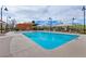 Community pool featuring clear blue water, lounge chairs, and shaded areas for relaxation at 3045 Camino Rico Ave, Henderson, NV 89044