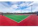 Well-maintained tennis court with red and green surfaces, ready for a competitive match at 3045 Camino Rico Ave, Henderson, NV 89044