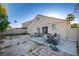 A backyard with sparse vegetation and a patio with a table and chairs at 320 Ellen Marie Dr, Las Vegas, NV 89110