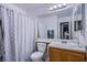 Bathroom with white shower curtain, white toilet, and wooden vanity at 320 Ellen Marie Dr, Las Vegas, NV 89110