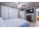 Bedroom featuring large closet, tv, ceiling fan and lots of light at 320 Ellen Marie Dr, Las Vegas, NV 89110