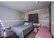 This bedroom has a grey bed spread and natural light from the window at 320 Ellen Marie Dr, Las Vegas, NV 89110