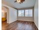 The primary bedroom showcases laminate flooring, a ceiling fan, generous windows, and an arched entry to the bathroom at 3336 Hidden Ridge St, Las Vegas, NV 89129