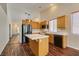 Bright kitchen area has wood cabinets and a center island at 3336 Hidden Ridge St, Las Vegas, NV 89129