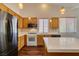 Kitchen with wood cabinets, tiled backsplash and modern appliances at 3336 Hidden Ridge St, Las Vegas, NV 89129