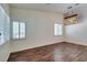 Bright living room featuring wood floors, plantation shutters, and decorative lighting at 3336 Hidden Ridge St, Las Vegas, NV 89129