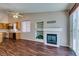 Open-concept living room features wood floors, fireplace, and access to the kitchen at 3336 Hidden Ridge St, Las Vegas, NV 89129