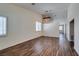 Bright living room featuring wood floors, plantation shutters, and decorative lighting at 3336 Hidden Ridge St, Las Vegas, NV 89129