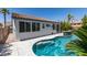 The inground backyard swimming pool has a connected spa and mature landscaping for backyard privacy at 3336 Hidden Ridge St, Las Vegas, NV 89129