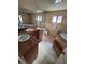 Bathroom showcasing dual sinks, a jacuzzi tub, and tiled flooring at 3480 E Hacienda Ave, Las Vegas, NV 89120