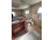Bathroom featuring a vanity with granite countertop, tiled flooring, and commode at 3480 E Hacienda Ave, Las Vegas, NV 89120